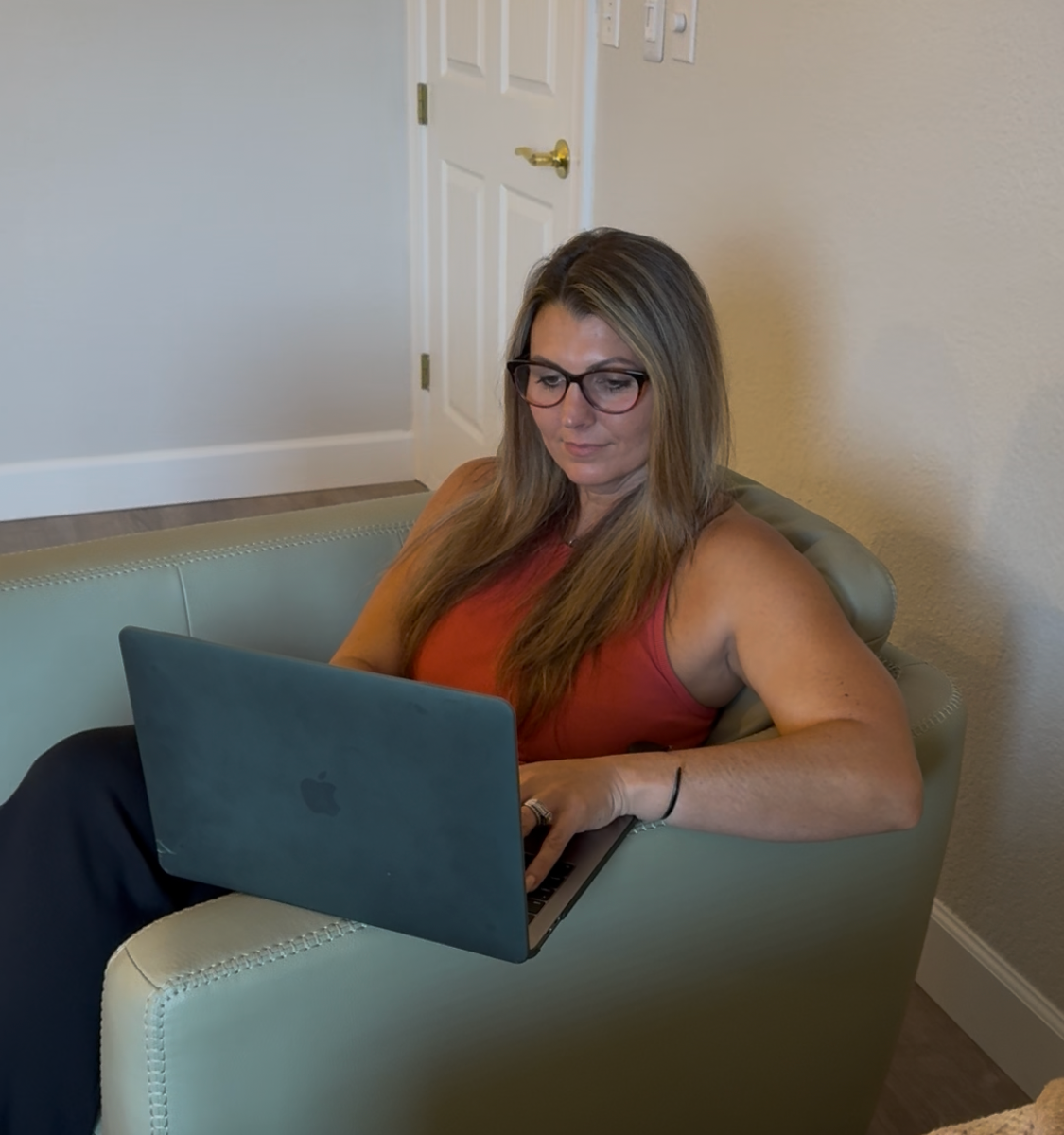 Lisa Rowe working thoughtfully on a laptop